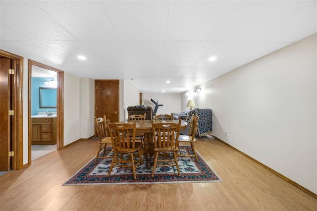 30 Fawn View Ln, Ofallon, MO 63366 - dining space featuring light wood-type flooring, baseboards, and a paneled ceiling