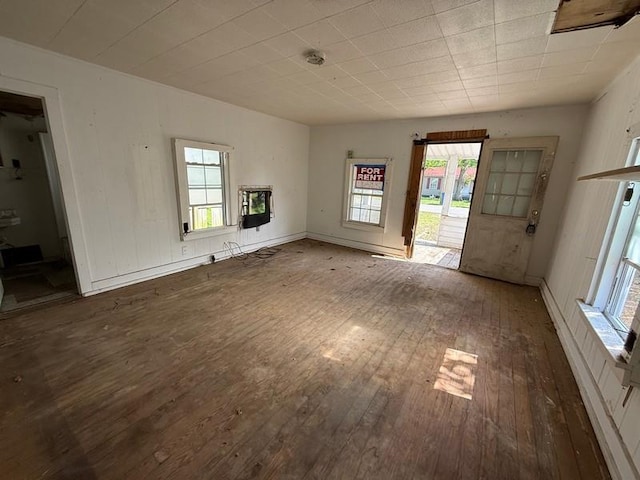 504 E 8th St, Portageville, MO 63873 - unfurnished living room featuring plenty of natural light and wood-type flooring