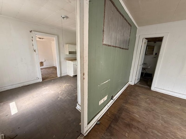 504 E 8th St, Portageville, MO 63873 - corridor featuring wood finished floors and wooden walls