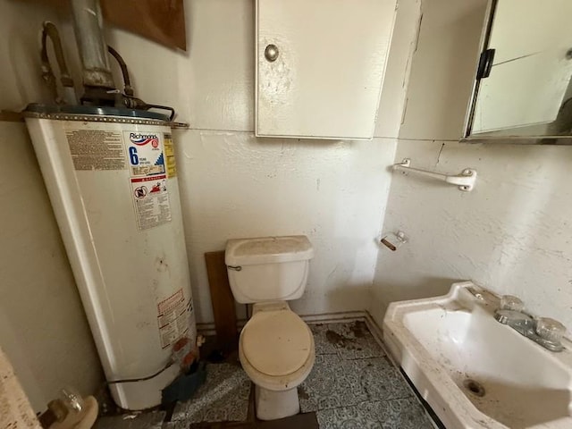 504 E 8th St, Portageville, MO 63873 - bathroom with gas water heater, a sink, and toilet