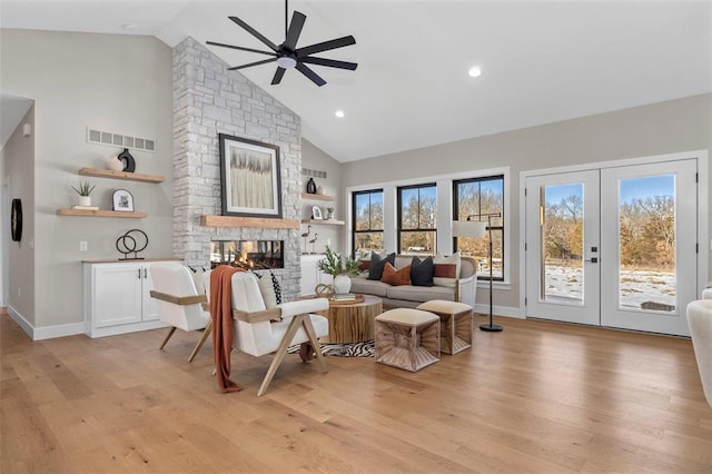 973 Buckner Rd, Wentzville, MO 63385 - living area with a ceiling fan, a stone fireplace, high vaulted ceiling, light wood-style floors, and baseboards