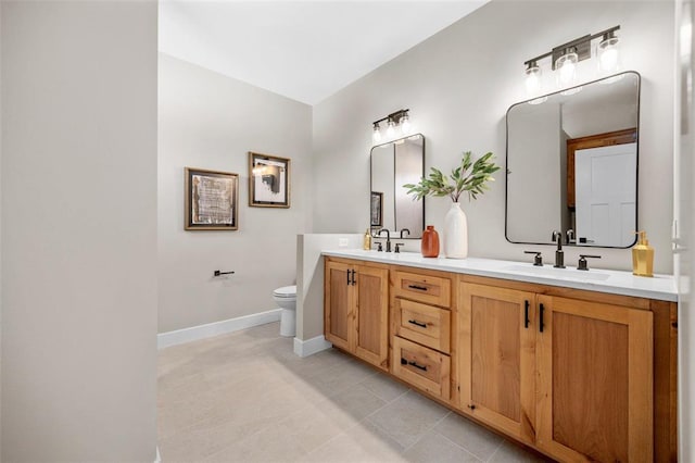 973 Buckner Rd, Wentzville, MO 63385 - bathroom with double vanity, toilet, baseboards, and tile patterned flooring