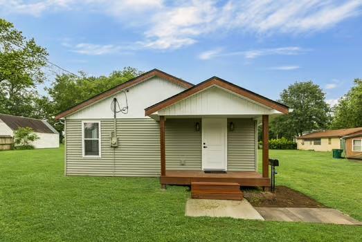 121 Douglas St, Ofallon, IL 62269 - rear view of house featuring a lawn