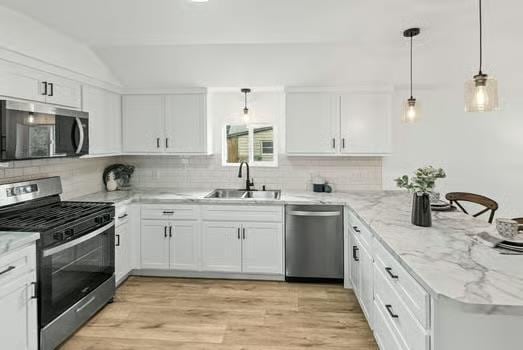 121 Douglas St, Ofallon, IL 62269 - kitchen featuring stainless steel appliances, a sink, a peninsula, white cabinets, and decorative backsplash