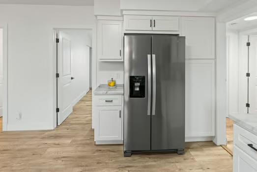 121 Douglas St, Ofallon, IL 62269 - kitchen with stainless steel fridge with ice dispenser, white cabinets, light wood-type flooring, and light countertops