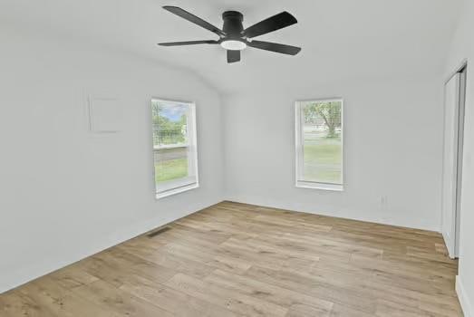 121 Douglas St, Ofallon, IL 62269 - spare room featuring healthy amount of natural light, vaulted ceiling, light wood-style flooring, and a ceiling fan