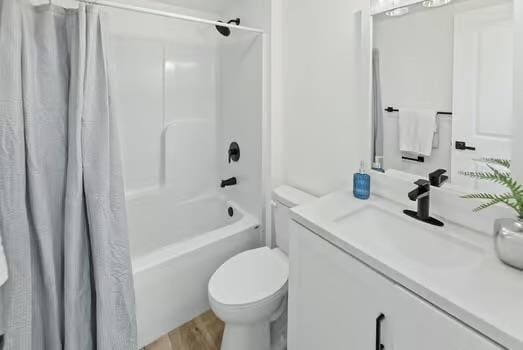 121 Douglas St, Ofallon, IL 62269 - full bathroom featuring toilet, vanity, shower / bath combo with shower curtain, and wood finished floors