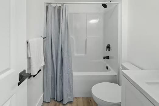 121 Douglas St, Ofallon, IL 62269 - bathroom with shower / bath combination with curtain, toilet, wood finished floors, and vanity