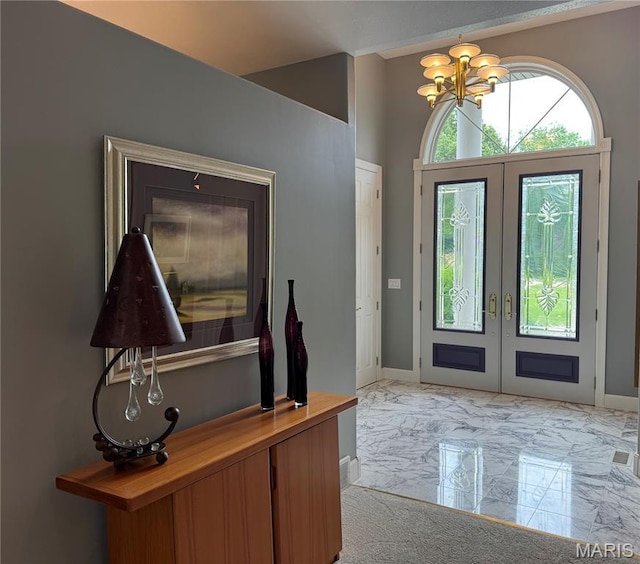 2700 Hyacinth Ave, Hannibal, MO 63401 - foyer entrance with french doors, light marble finish floors, a chandelier, and baseboards
