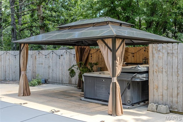 700 Lariat Ln, Rolla, MO 65401 - view of patio featuring a gazebo, a hot tub, and view of scattered trees