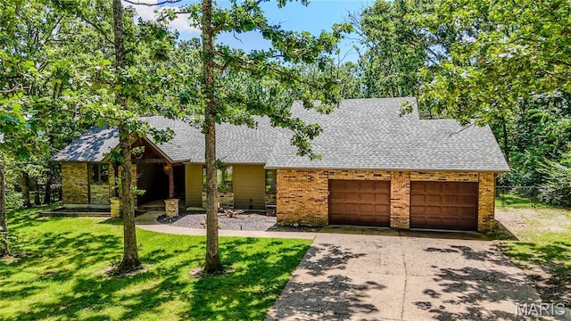 700 Lariat Ln, Rolla, MO 65401 - view of front of property featuring a shingled roof, a garage, brick siding, and concrete driveway