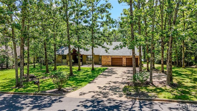 700 Lariat Ln, Rolla, MO 65401 - view of front facade featuring a garage, driveway, brick siding, a front lawn, and roof with shingles