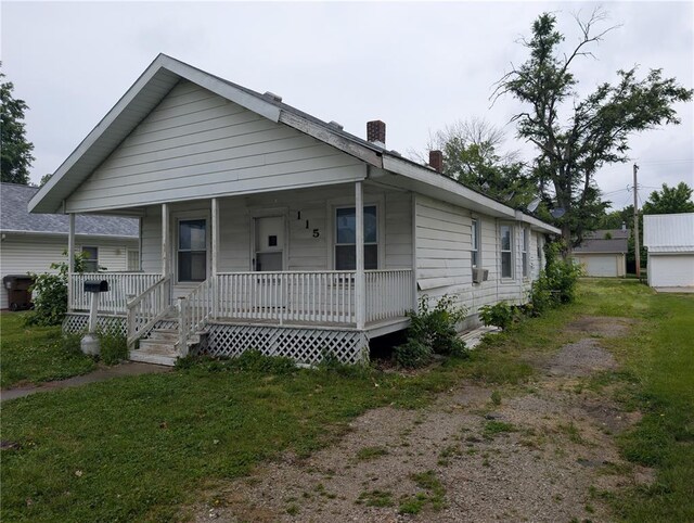 115 W Maple St, Gillespie, IL 62033 - view of front facade featuring covered porch and a chimney