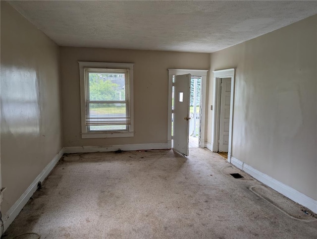 115 W Maple St, Gillespie, IL 62033 - foyer featuring carpet floors, a textured ceiling, and baseboards