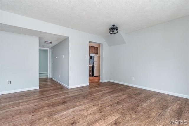1447 Oriole Pl, Brentwood, MO 63144 - spare room with wood finished floors, baseboards, and a textured ceiling