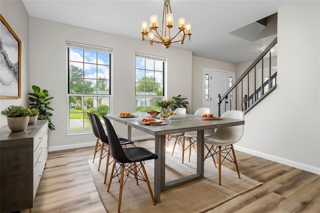 904 Hunter Ln, Lake St Louis, MO 63367 - dining space with light wood-type flooring, baseboards, a chandelier, and stairway