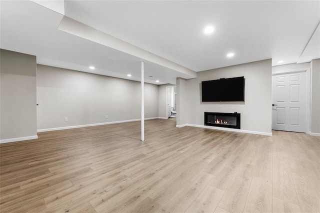 904 Hunter Ln, Lake St Louis, MO 63367 - finished basement featuring light wood-style flooring, baseboards, recessed lighting, and a glass covered fireplace