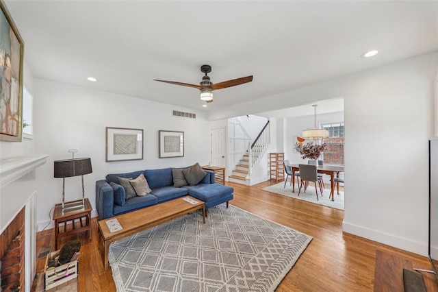 6708 Etzel Ave, University City, MO 63130 - living area with stairway, wood finished floors, a ceiling fan, recessed lighting, and baseboards