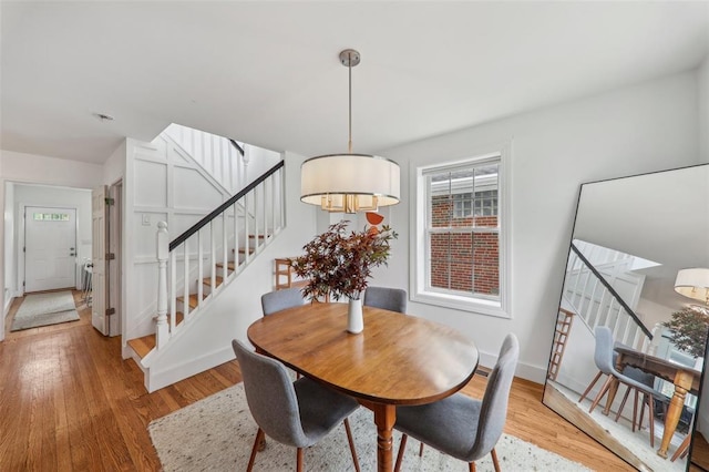 6708 Etzel Ave, University City, MO 63130 - dining space with stairs, light wood-type flooring, and baseboards