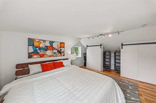 6708 Etzel Ave, University City, MO 63130 - bedroom with wood finished floors, a barn door, and lofted ceiling