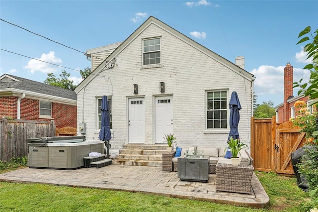6708 Etzel Ave, University City, MO 63130 - rear view of property with entry steps, a hot tub, a fenced backyard, and brick siding