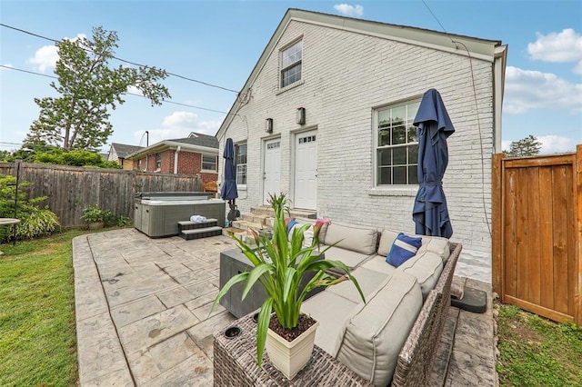 6708 Etzel Ave, University City, MO 63130 - back of property with a hot tub, a patio, brick siding, and a fenced backyard