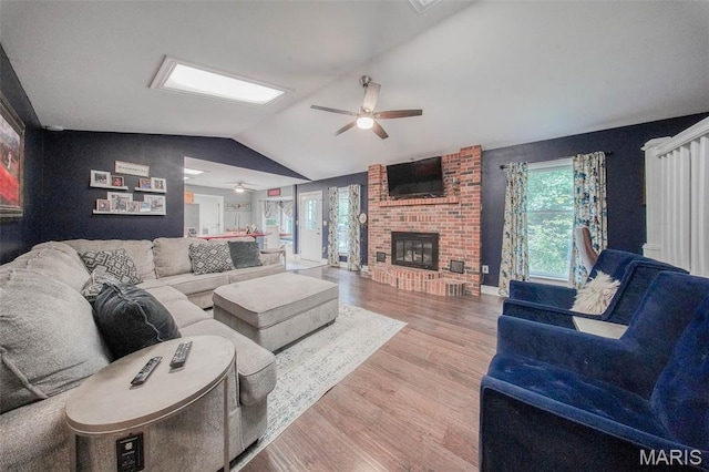 1708 Line Ave, Rolla, MO 65401 - living area featuring ceiling fan, vaulted ceiling, wood finished floors, and a brick fireplace