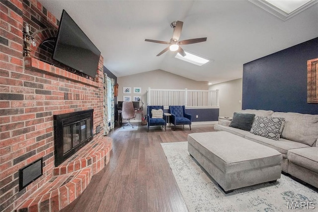 1708 Line Ave, Rolla, MO 65401 - living area featuring a fireplace, wood finished floors, ceiling fan, vaulted ceiling, and baseboards