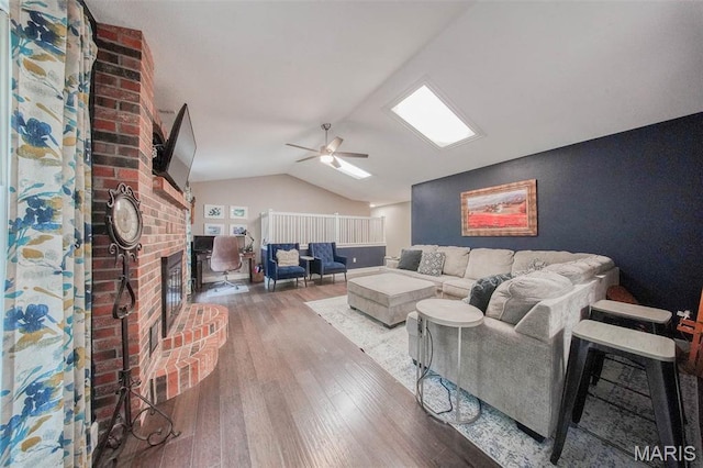 1708 Line Ave, Rolla, MO 65401 - living area featuring wood-type flooring, lofted ceiling, a brick fireplace, and a ceiling fan