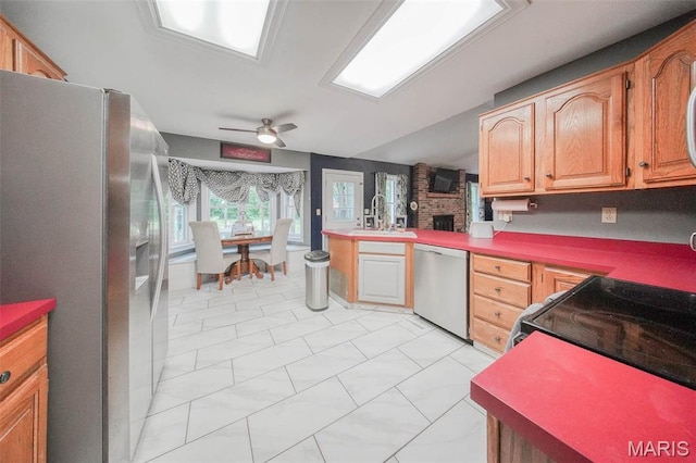 1708 Line Ave, Rolla, MO 65401 - kitchen featuring appliances with stainless steel finishes, a sink, a ceiling fan, a peninsula, and light marble finish flooring