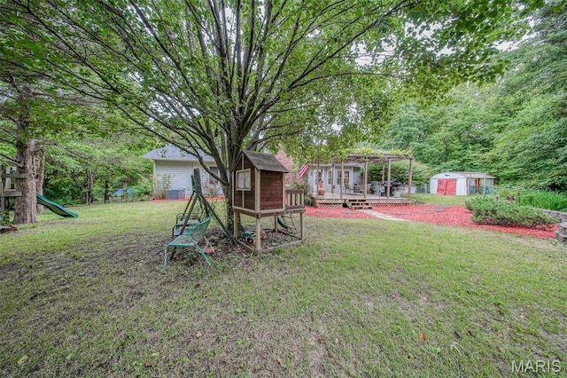 1708 Line Ave, Rolla, MO 65401 - view of green lawn featuring a wooden deck and a playground