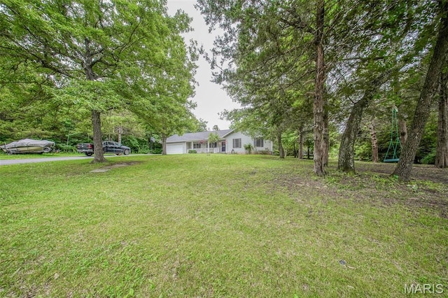 1708 Line Ave, Rolla, MO 65401 - view of green lawn with a garage and driveway