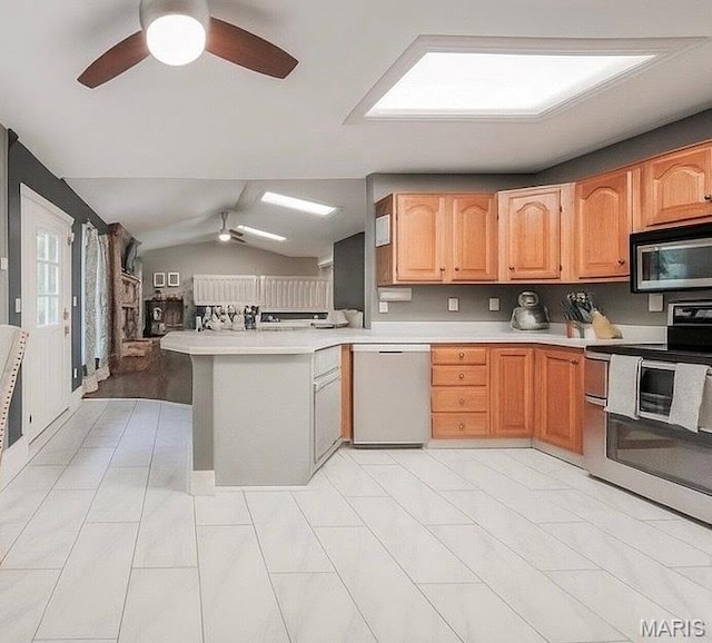 1708 Line Ave, Rolla, MO 65401 - kitchen featuring appliances with stainless steel finishes, a ceiling fan, a peninsula, light countertops, and vaulted ceiling