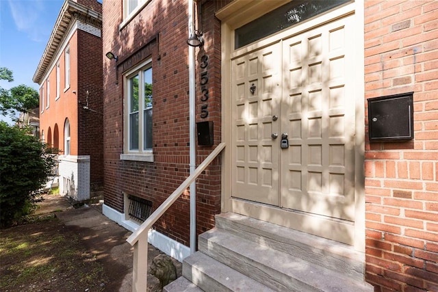 3535 Giles Ave, Saint Louis, MO 63116 - view of exterior entry with brick siding and a garage