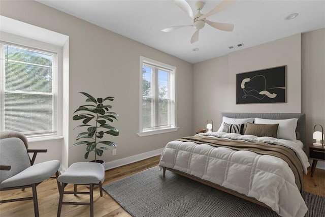 3535 Giles Ave, Saint Louis, MO 63116 - bedroom with multiple windows, wood finished floors, baseboards, and ceiling fan