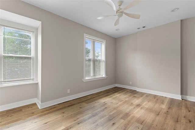 3535 Giles Ave, Saint Louis, MO 63116 - unfurnished room featuring plenty of natural light, baseboards, and light wood-style floors