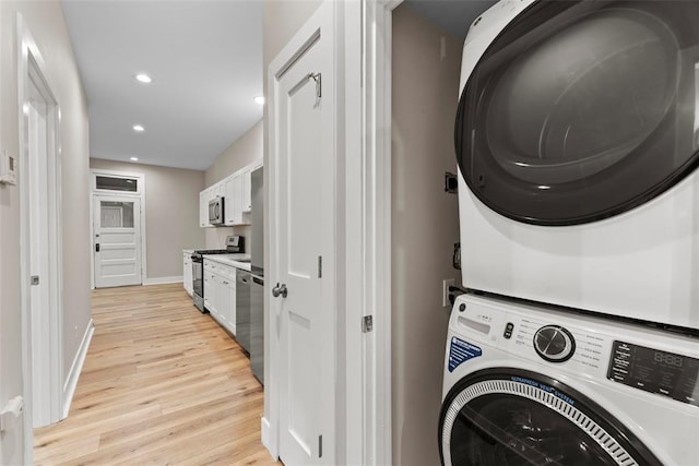 3535 Giles Ave, Saint Louis, MO 63116 - laundry area with stacked washer and clothes dryer, light wood-style floors, recessed lighting, and baseboards