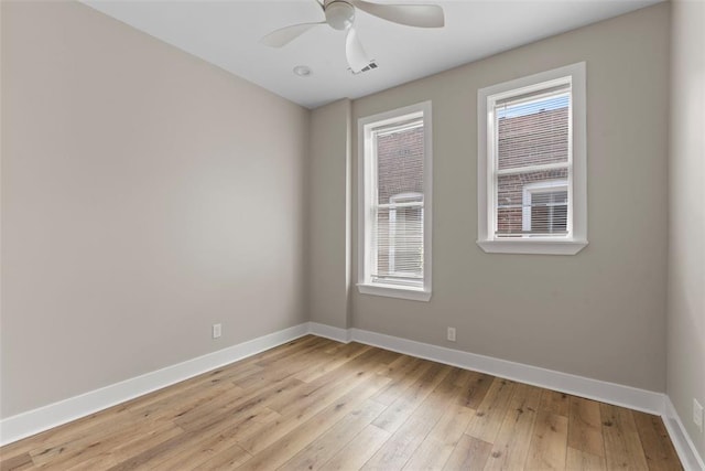 3535 Giles Ave, Saint Louis, MO 63116 - unfurnished room featuring baseboards, plenty of natural light, and light wood-type flooring