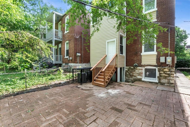 3535 Giles Ave, Saint Louis, MO 63116 - rear view of property with central AC unit, entry steps, brick siding, and a patio
