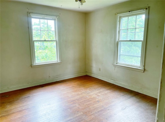 708 E State Route 72, Rolla, MO 65401 - spare room featuring wood finished floors, plenty of natural light, and baseboards