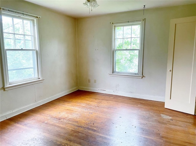 708 E State Route 72, Rolla, MO 65401 - empty room with wood finished floors, healthy amount of natural light, and baseboards