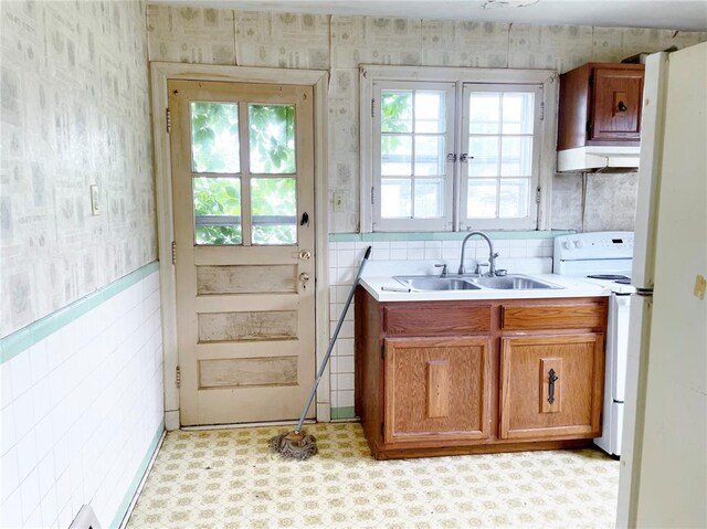 708 E State Route 72, Rolla, MO 65401 - kitchen featuring wallpapered walls, a sink, electric range, brown cabinets, and light countertops