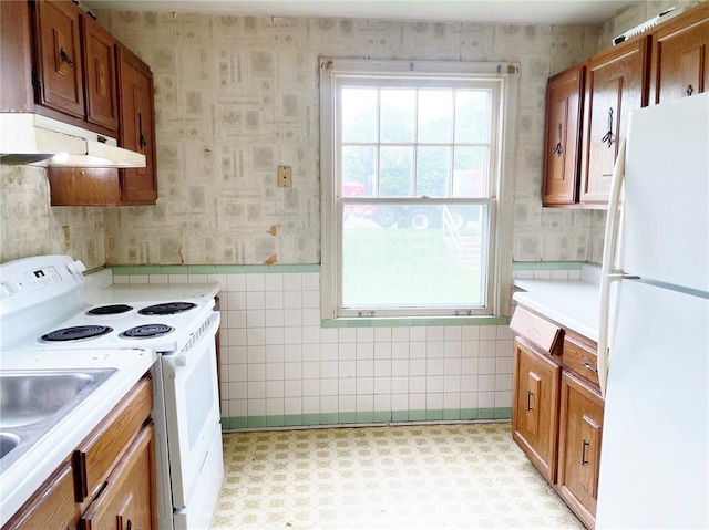 708 E State Route 72, Rolla, MO 65401 - kitchen featuring white appliances, wallpapered walls, brown cabinetry, light countertops, and a sink
