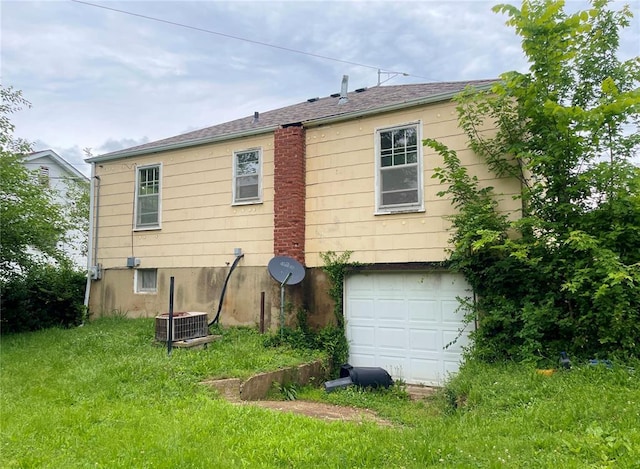 708 E State Route 72, Rolla, MO 65401 - rear view of house with a garage and cooling unit