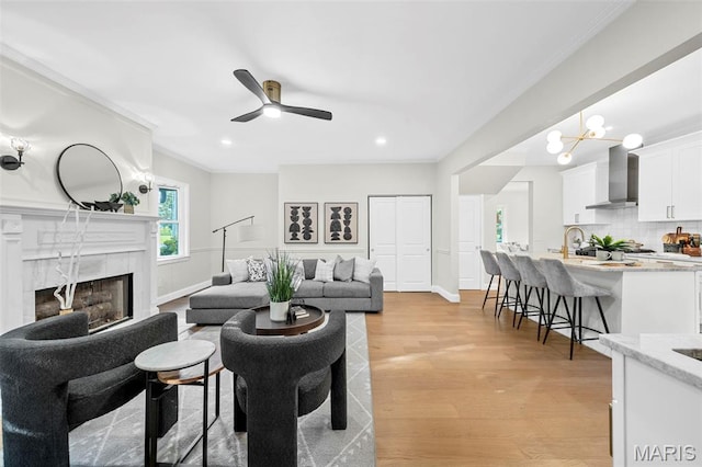 317 Greeley Ave, Webster Groves, MO 63119 - living area with light wood-style flooring, a ceiling fan, ornamental molding, a fireplace, and recessed lighting