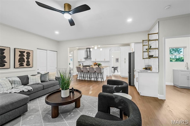 317 Greeley Ave, Webster Groves, MO 63119 - living room with light wood-style flooring, crown molding, a ceiling fan, and recessed lighting