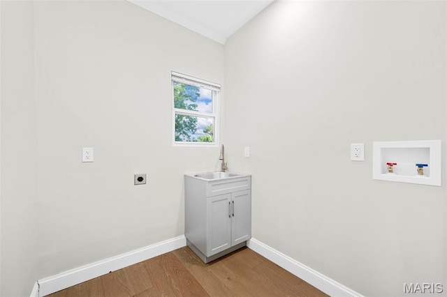317 Greeley Ave, Webster Groves, MO 63119 - laundry room featuring electric dryer hookup, washer hookup, light wood-style flooring, and cabinet space