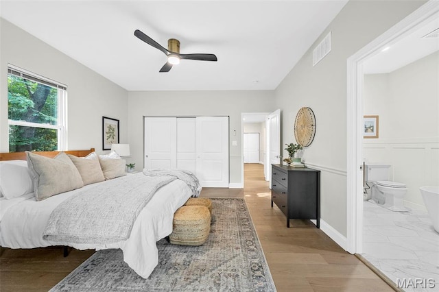 317 Greeley Ave, Webster Groves, MO 63119 - bedroom featuring a closet, wood finished floors, ensuite bathroom, and a ceiling fan