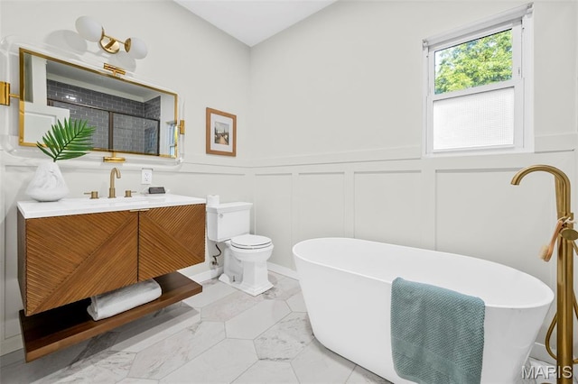 317 Greeley Ave, Webster Groves, MO 63119 - bathroom with a decorative wall, vanity, a freestanding bath, a wainscoted wall, and marble look tile flooring