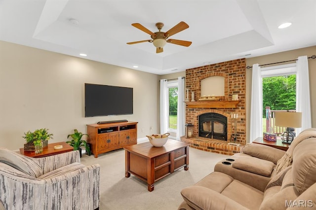 61 Serenity Ln, Troy, MO 63379 - living room with a tray ceiling, light carpet, ceiling fan, a fireplace, and recessed lighting